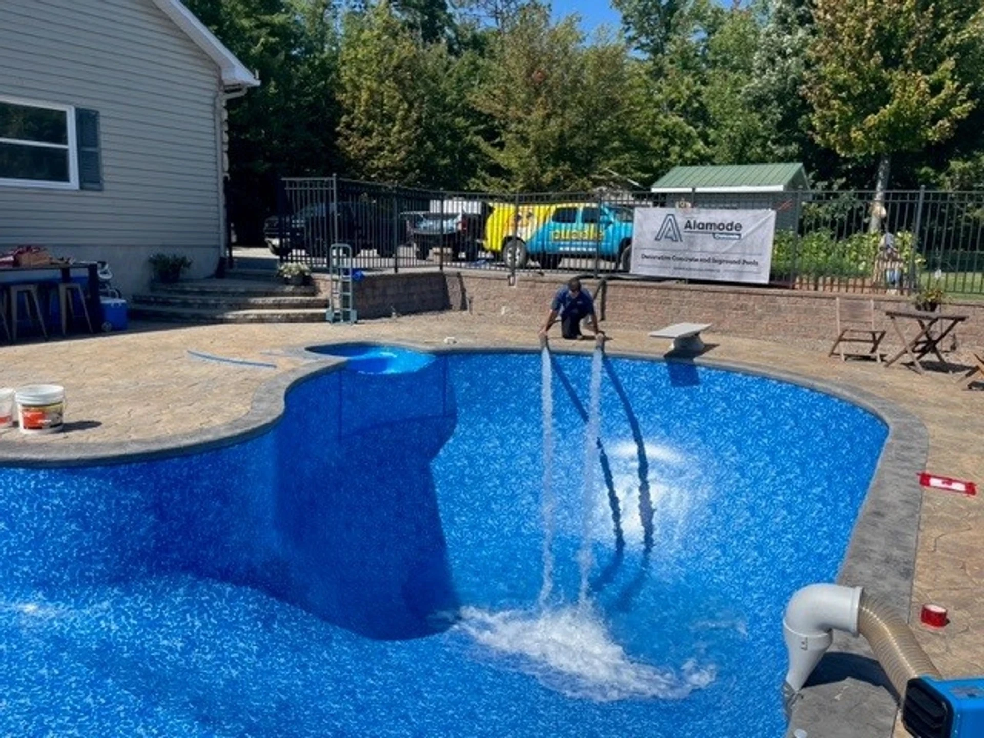 Puddle Pool Services technician in branded uniform working at a residential pool
